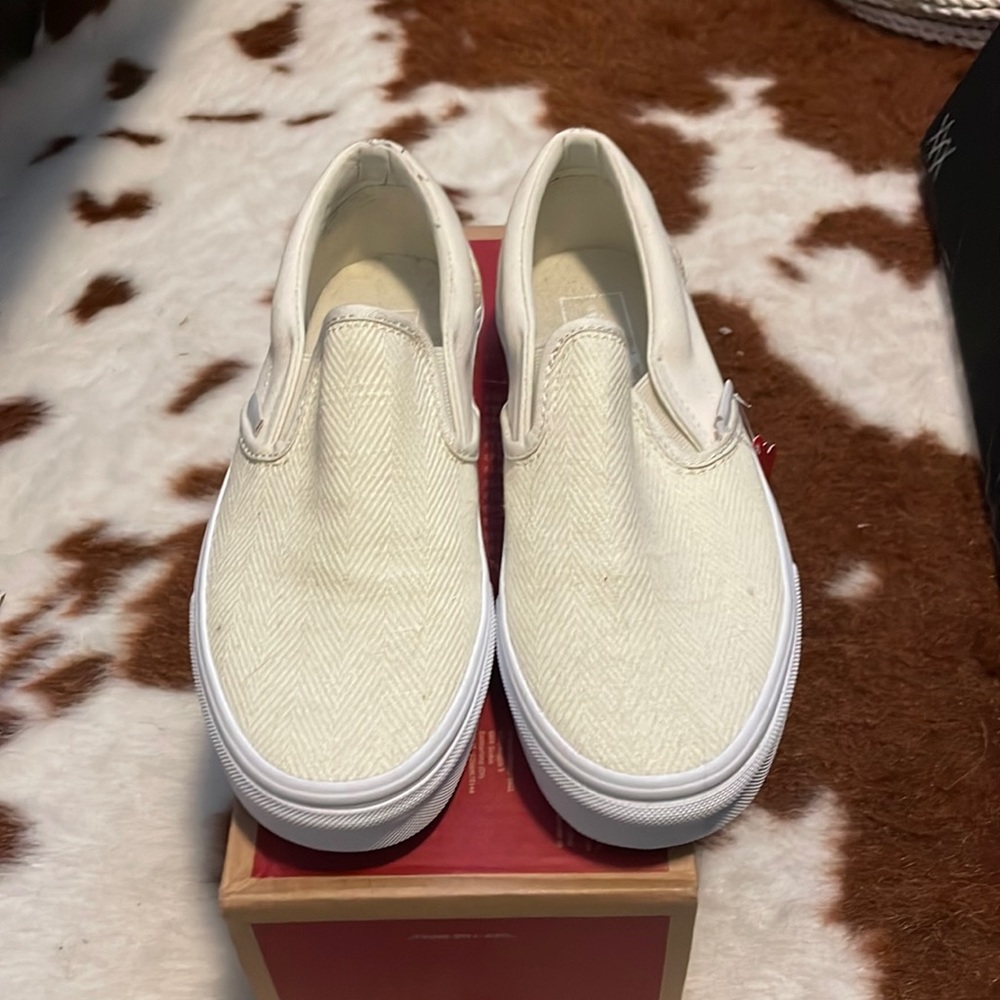 Vans cream slip on sneakers.